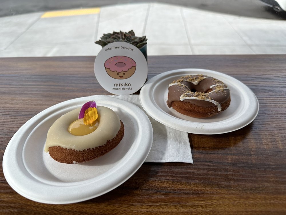 A donut each on a plate at Mikiki Mochi Donuts.