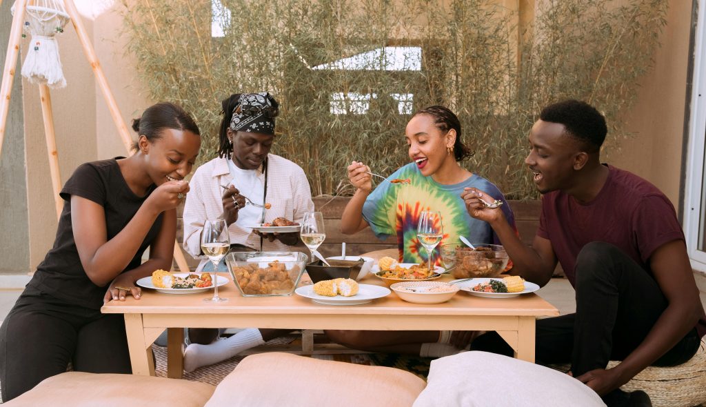 A group of young people eating joyfully.